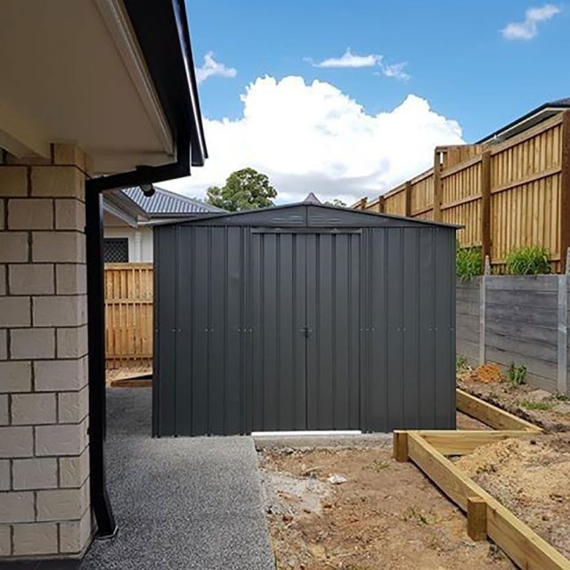 insitu image from a distance  with double doors closed on the 8x6 Lotus Metal Shed in Anthracite Gre